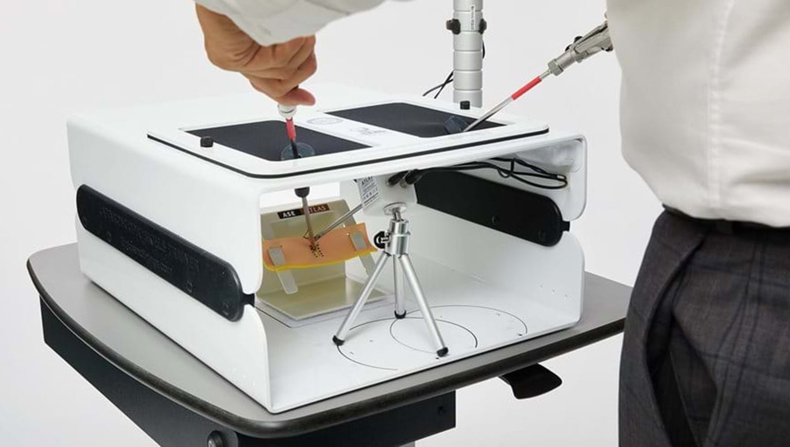 The Advanced Training in Laparoscopic Suturing (ATLAS) training kit is a laparoscopic surgery simulator designed to deliver high level minimally invasive suturing training